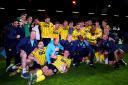 Oxford United's players and staff celebrate victory over Peterborough United in the play-offs