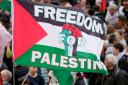 People wave flags during a Pro-Palestinian demonstration in Eurovision host city Malmo (Martin Meissner/AP)