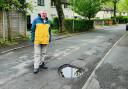Cllr David Wilkinson with potholes in Westoughton