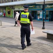 PC Dillon handing out retail packs in Bolton Town Centre