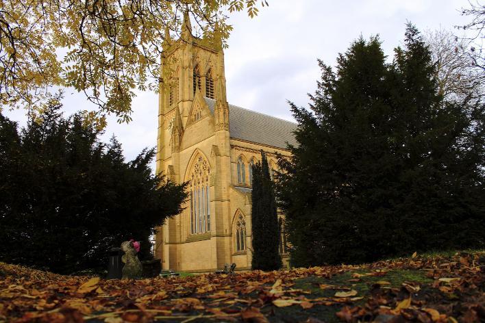 This photograph shows a seasonal view of Bolton Parish Church, with orange and brown leaves still on one of the trees but many more scattered on the ground. 
It was taken by reader Philip Gerrard, of Little Lever.
