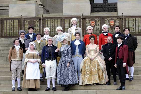 The cast of the award-winning Madness of George III posing in costume on the steps of the Town Hall.