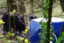 Police officers by a forensic tent at Kersal Dale. Picture PA