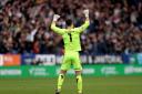 Wanderers goalkeeper Nathan Baxter celebrates after Aaron Collins' equaliser against Portsmouth