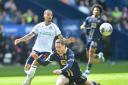 Bolton Wanderers' Josh Dacres-Cogley battles with Port Vale's Conor Grant