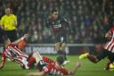 LET IT FLOW: Referee Kevin Friend keeps a watching brief as the Southampton defenders dive in on Liverpool goalscorer Raheem Sterling