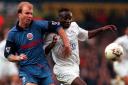 Bolton Wanderers defender Simon Coleman, after recovering from his broken leg, fends off Leeds striker Tony Yeboah