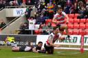 Liam Kay leaps out of the way as Tom Armstrong dives in for his second try. Picture by Brian King