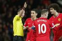 Referee Michael Oliver sends off Manchester United's Angel Di Maria on Monday night