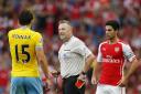 Referee Jon Moss talks with Crystal Palace's Mile Jedinak (left) as Arsenal's Mikel Arteta looks on. Moss will renew acquaintances with Arsenal in the FA Cup final.