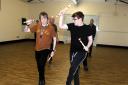Bolton News reporter Thomas Molloy is put through his paces by Richard Hall when he tried Morris dance fitness with the Horwich Prize Medal Morris Men.