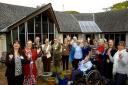 Staff and residents at St Mary's Hospice celebrate in the courtyard that will be transformed by the Gannett grant