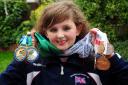 Beth Morris of Hollow Meadows, Ringley, with her medals, four gold and three silver, which she won at last year’s event. Beth had a bone marrow transplant a few years ago and now swims and cycles for Great Britain in transplant competitions
