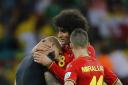 Tim Howard is consoled by Marouane Fellaini and Kevin Mirallas following his heroic display in the USA's second-round defeat to Belgium