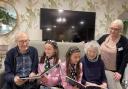 School children share stories with older residents during special visit