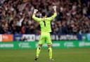 Wanderers goalkeeper Nathan Baxter celebrates after Aaron Collins' equaliser against Portsmouth
