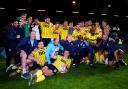 Oxford United's players and staff celebrate victory over Peterborough United in the play-offs
