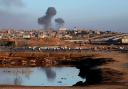 Smoke rises after an Israeli air strike near the separating wall between Egypt and Rafah