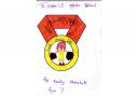 WINNER: Keeley Marshall, aged seven, a pupil at St John’s CE Infants School in Leigh, choose a cheerleader as the focal point of her medal, with shiny paper for the pom poms.