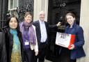 Bolton News reporter Elaine O’Flynn hands in our Let’s Get Back on Track Petition to Number 10 Downing Street, with local MPs, from left, Yasmin Qureshi, Julie Hilling and David Crausby