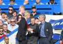 Fourth official Jon Moss gets in between rival bosses Arsene Wenger and Jose Mourinho last weekend