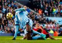 Marcos Rojo tackles Yaya Toure in the box during Sunday's Manchester derby