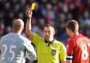 Kevin Friend, who is in charge of Wanderers' FA Cup match at Anfield on Saturday, shows Liverpool keeper Pepe Reina a yellow card in a cup quarter-final tie against Stoke