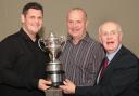 Martin Axford, middle, presents the Anthony Axford Bolton Cricket League title trophy to Christian Walsh, left, joint captain of last season's champions Farnworth Social Circle with league chairman Mike Hall, right