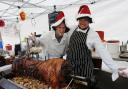 MEATY: Aaron Marsden, left, and stallholder Graham Eyes carve up a hog roast