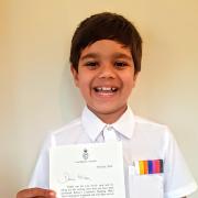 PROUD:Milan holding his well-deserved certificate from The Duchess of Cornwall. The eight-year-old received it through the post for all of his efforts in his reading challenge.
