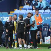 Bolton Wanderers manager Ian Evatt and Sheffield Wednesday manager Darren Moore embrace at the end of the match