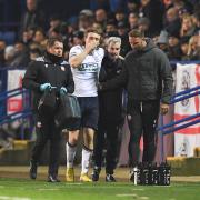 Jon Dadi Bodvarsson comes off the pitch with concussion and a bloody nose.