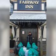 Val Coyle, landlady of the Fairway Inn , New Moston, with a collection of items