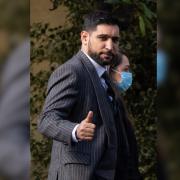 Former world boxing champion Amir Khan, gives a thumbs up as he arrives at Snaresbrook Crown Court, in east London