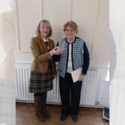 Inner Wheel Club of Horwich President Katie Maher presenting Eileen Dickinson with her tumbler