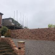 The new wall at the end of the street, with the beginnings of the new house behind it