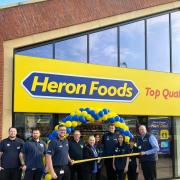 Heron Foods cutting the ribbon to open the store