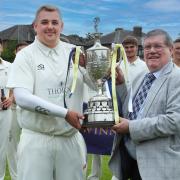 Padiham skipper Toby Burrows receives the NWCL Hamer Cup from Frank Hinks, of sponsors JD Consultancy, last season. Picture by Harry McGuire