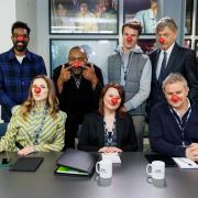 Sir Lenny Henry, with (left to right) Romesh Ranganathan, Jessica Hynes, Monica Dolan, Hugh Skinner, Hugh Bonneville, and Richard Madeley, during the filming of his W1A replacement sketch as part of the Red Nose Day 2024 campaign