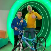 Croston Cycles' Mark Gallagher together with BLGC Member Jordan and one of the bikes donated