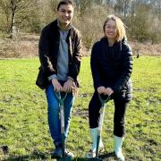 : Cllr Nadim Muslim and Cllr Amy Cowen planting some of the 400 new trees at Eagley Valley that will create the new woodland area