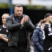 Ian Evatt applauds the fans after the final whistle at Peterborough