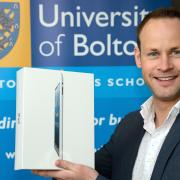 Octagon Theatre Bolton Chief Executive, Roddy Gauld, is the winner of the Bolton Business School (BBS) launch competition and has promptly donated the iPad prize to the theatre