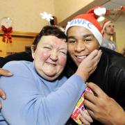 Ann Butler gets a Christmas cuddle from Zat Knight