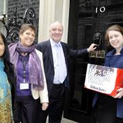 Bolton News reporter Elaine O’Flynn hands in our Let’s Get Back on Track Petition to Number 10 Downing Street, with local MPs, from left, Yasmin Qureshi, Julie Hilling and David Crausby