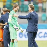 Netherlands keeper Tim Krul is congratulated by coach Louis Van Gaal after his penalty shootout heroics on Saturday