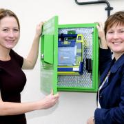 Judith Kelly and pub manager Rebecca Dale with the defibrillator