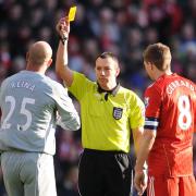 Kevin Friend, who is in charge of Wanderers' FA Cup match at Anfield on Saturday, shows Liverpool keeper Pepe Reina a yellow card in a cup quarter-final tie against Stoke