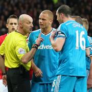 Referee Roger East mistakenly sends off Sunderland's Wes Brown as John O'Shea appeals at Old Trafford