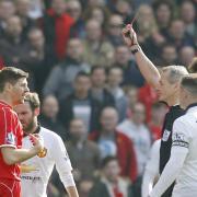 Steven Gerrard is shown red by referee Martin Atkinson at Anfield on Sunday